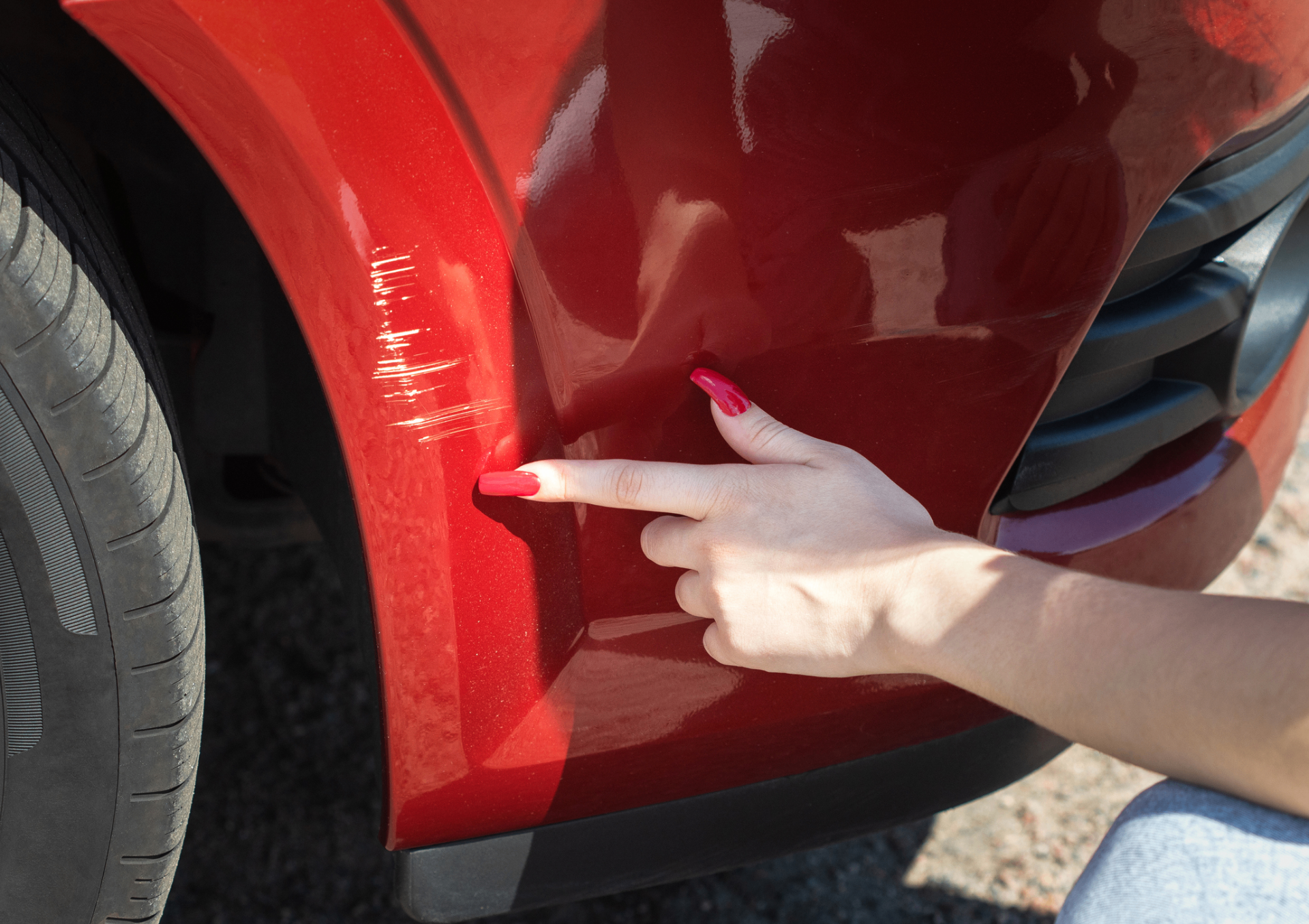 Customer inspecting car door for scratches and damage at car wash